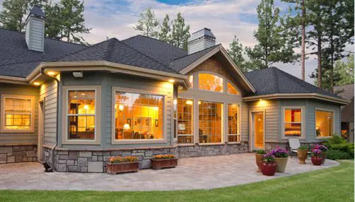 Siding by the Best - newly renovated home at dusk with lights on inside